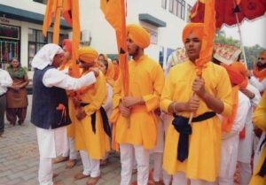 Welcoming the Panj Pyare with Garland